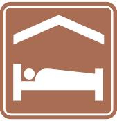 This sign shows accommodations ahead such as hotels or motels.